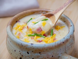 Spoonfull of creamy potato soup.