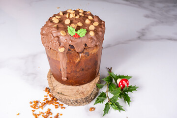 Panettone with melted chocolate frosting and peanuts alongside caramel crunch.