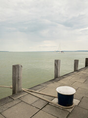 sailboat on lake balaton with mooring rope and cloudy sky