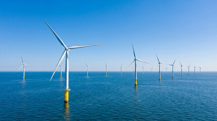 Offshore wind turbines standing in the open sea, generating clean and renewable energy. Aerial view highlighting sustainable power production, modern energy infrastructure, environmentally friendly