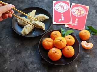 Auspicious foods during Chinese New Year include oranges and dumplings