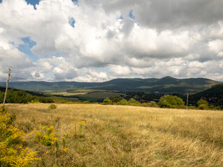 grassy field with view of buda hills and village