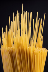 thin long hard yellow spaghetti made from durum flour using water , not cooked hard spaghetti made from wheat flour