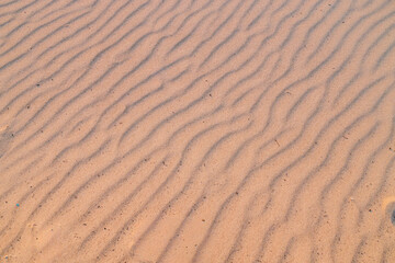 Fototapeta premium High angle view of wind ripples on sand dunes at the sunset