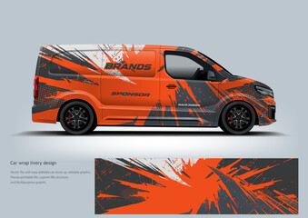 A bold orange and grey racing wrap with sharp angular lines that emphasize speed, power, and aggressive performance.