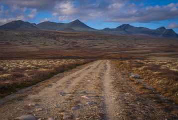 Mountain landscape with gravel road in Rondane, Norway