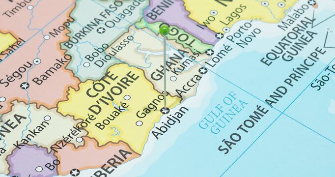 A zoom out of a green pin into Abidjan city of Cote D Ivory political map
