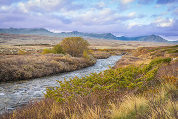 Winding river through autumn tundra in Rondane National Park