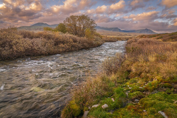 Winding river through autumn tundra in Rondane National Park