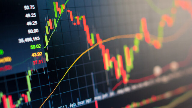 Analyzing real-time financial market trends and stock performance with vibrant candlestick charts and data displayed on a digital screen, symbolizing investment analysis and global economic activity - Powered by Adobe