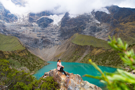 Latina tourist resting in front of Lake Humantay in Cusco, manoramic view of the Peruvian Andes