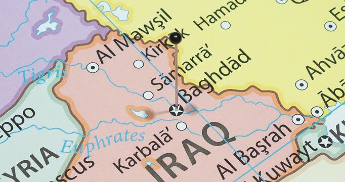 A zoom out of a black pin into Baghdad city of Iraq political map