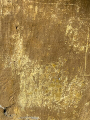 old yellowish brown wall with peeling texture