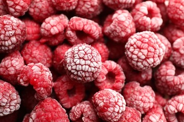 Frozen ripe raspberries as background, above view