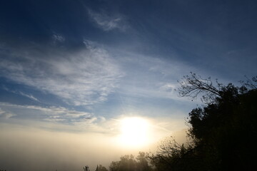 Stunning sunrise from a mountain top over the clouds