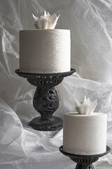 Toilet paper tissue rolls turn into candlelight sculptures announcing the New Year color tone, cloud dancer white. Candle & flame is a paper sculpture on metal candle holder. or a  toilet paper roll.