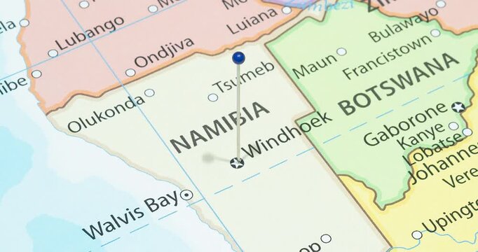 A zoom out of a blue pin into windhoek city of namibia political map