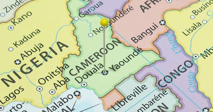 A zoom out of a yellow pin into yaounde city of cameroon political map