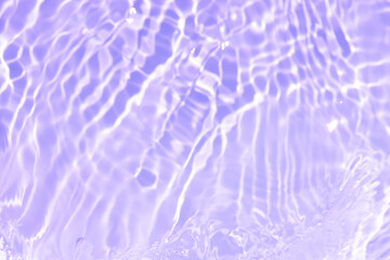 Purple water bubbles on the surface ripples. Defocus blurred transparent pink colored clear calm water surface texture with splash and bubbles. Water waves with shining pattern texture background