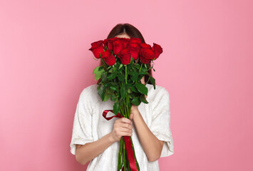 St. Valentine's Day. Woman with roses on pink background