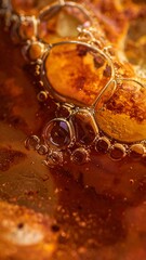 Close-up macro shot of vibrant orange and red oil bubbles on a liquid surface, showing intricate textures and reflections.