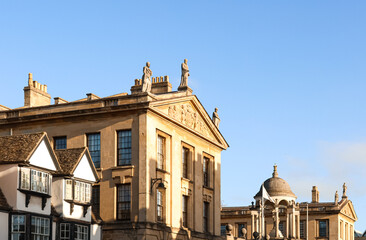 Historic buildings architecture in Oxford, England, showing classic colleges and traditional rooftops under clear sky