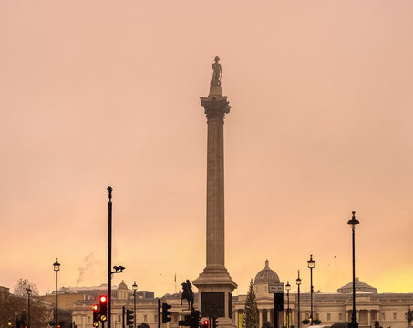 Nelson's Column standing tall in Trafalgar Square London, capturing the historic monument at sunset