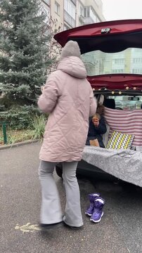 Enjoying a Cozy Car Picnic with Mother and Daughter during Winter Season