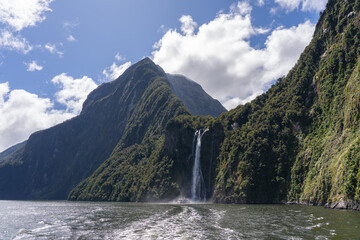 Majestic Bowen Falls and Fjord with Boat Wake in Milford Sound New Zealand