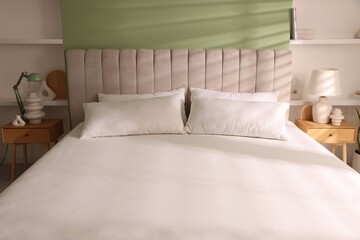Orthopedic mattress and pillows on bed indoors, closeup