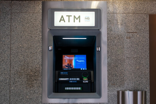 Modern ATM Machine Embedded in a Stone Wall