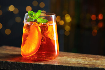 Refreshing spritzer cocktail on wooden table in bar, closeup. Space for text