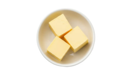 Three yellow butter cubes in a bowl isolated PNG, dairy product for cooking and baking on transparent background