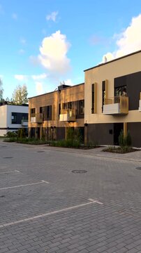 Landscape Design at Modern Townhouse. Duplex facade apartments. New TownHouse Exterior with Arborvitae, shrub juniper as Landscape. Urban Duplex townhome. Mulching pine bark a juniper in Landscaping. 