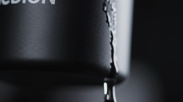 Macroscopic View of Water Droplets Forming and Falling from a Textured Surface