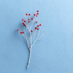 White branch with red berries on textured blue surface
