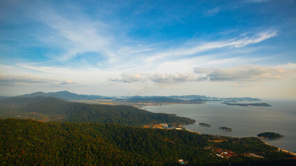 Amazing view from Langkawi's cable car: Majestic Gunung Machincang unfolds below, a tapestry of lush greenery and dramatic cliffs against azure skies. © Alexandra Lande