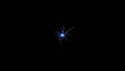 Fototapeta premium Blue Sparkler Explosion Against Dark Background