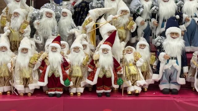 Row Of Santa Dolls On Shop Display Filling Shelves With Varied Red And White Costumes, Long Beards, Glittering Accessories HandCrafted Looks Suggest Bustling Holiday Market Stall, Festive