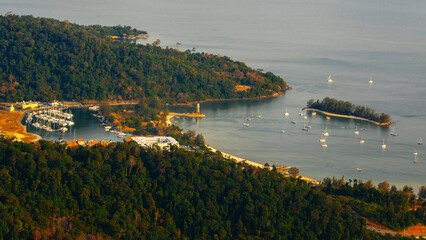 Amazing view from Langkawi's cable car: Majestic Gunung Machincang unfolds below, a tapestry of lush greenery and dramatic cliffs against azure skies. © Alexandra Lande