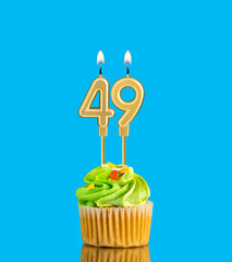 Birthday cupcake with candle number 49 - Blue background
