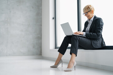 Mature businesswoman using laptop