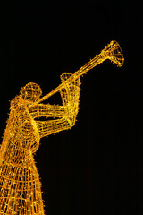A New Year's illuminated wire sculpture of a musician with a trumpet