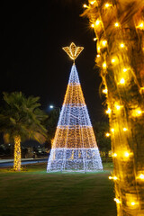 Christmas tree and palm tree garlands in the foreground