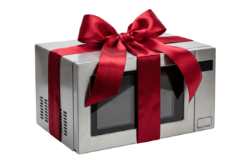 A stainless steel microwave oven wrapped with a red ribbon and bow, transparent background