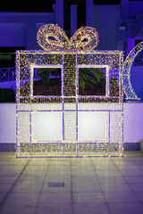 Large illuminated gift box decoration at night