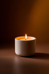 Cozy warmth of a lit candle illuminating a dark room