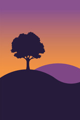 Silhouette of a lone tree on a hill against a vibrant gradient sunset sky