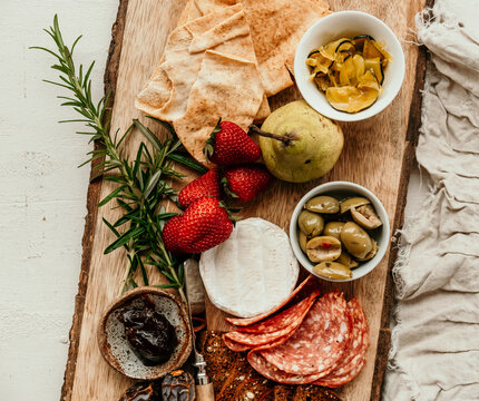 antipasto cheese board with fruit and nibbles