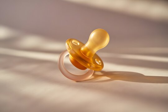 Baby pacifier with warm sunlight and soft shadows